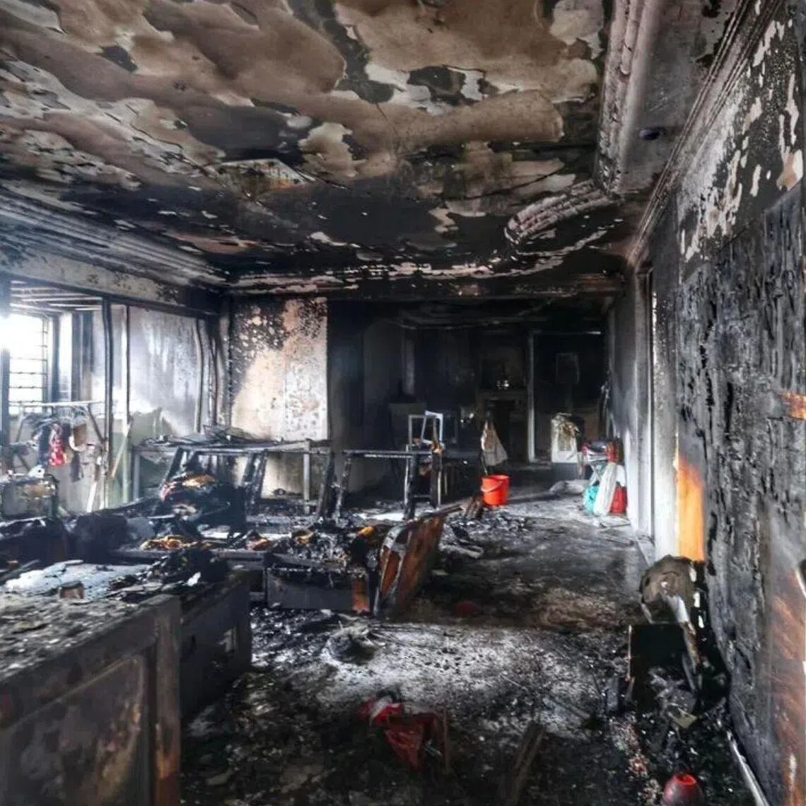 The walls and ceiling of the HDB flat in Jurong West were left blackened by the fire.