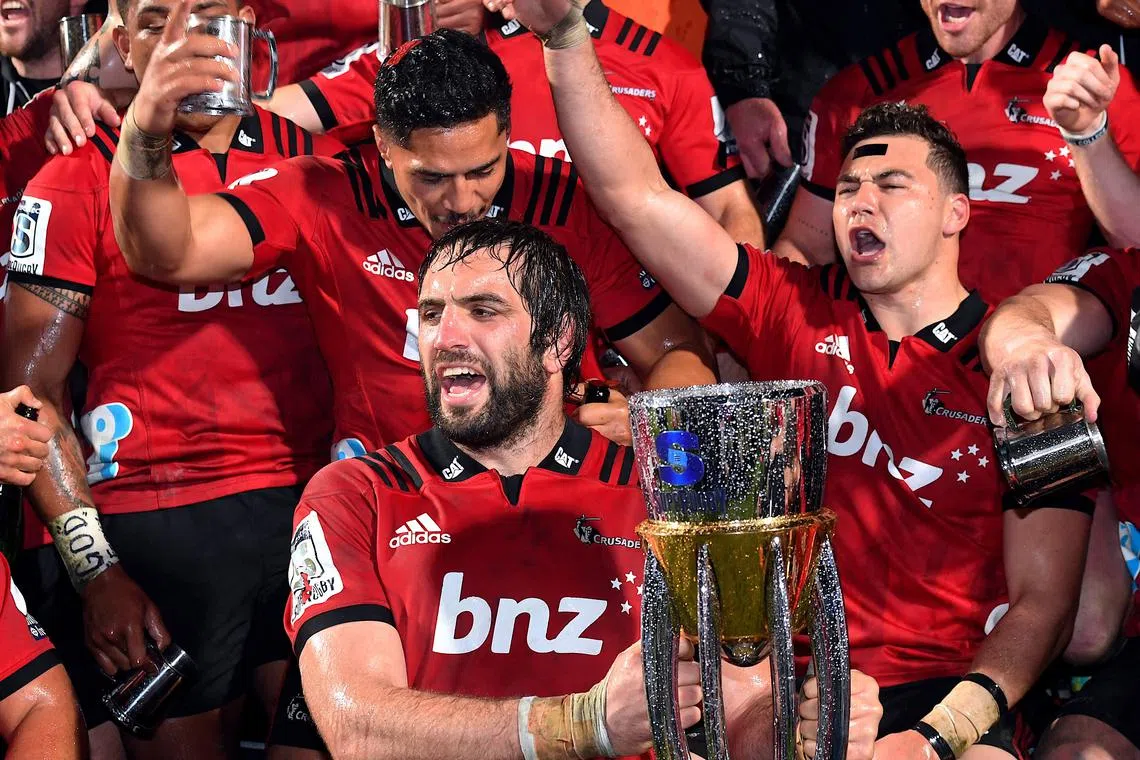 FILE PHOTO: Rugby Union - Super Rugby Final - Crusaders vs Lions - AMI Stadium, Christchurch, New Zealand - August 4, 2018 - Sam Whitlock of the Canterbury Crusaders holds the trophy as he celebrates with team mates after they defeated South Africa's Lions.    REUTERS/Stringer/File Photo