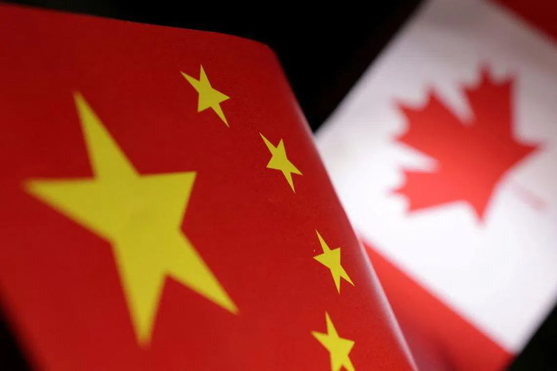 FILE PHOTO: Printed Chinese and Canada flags are seen in this illustration, July 21, 2022. REUTERS/Dado Ruvic/Illustration/File Photo