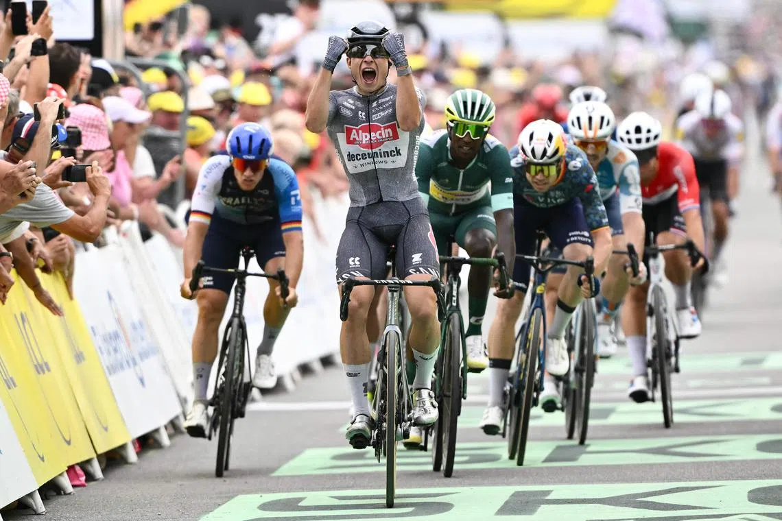 Alpecin-Deceuninck's Belgian rider Jasper Philipsen cycling past the finishing line to win ahead of second-placed Intermarche-Wanty's Eritrean rider Biniam Girmay (third from left) and third-placed Israel-Premier Tech's German rider Pascal Ackermann (left) in Stage 10 of the Tour de France between Orleans and Saint-Amand-Montrond on July 9.