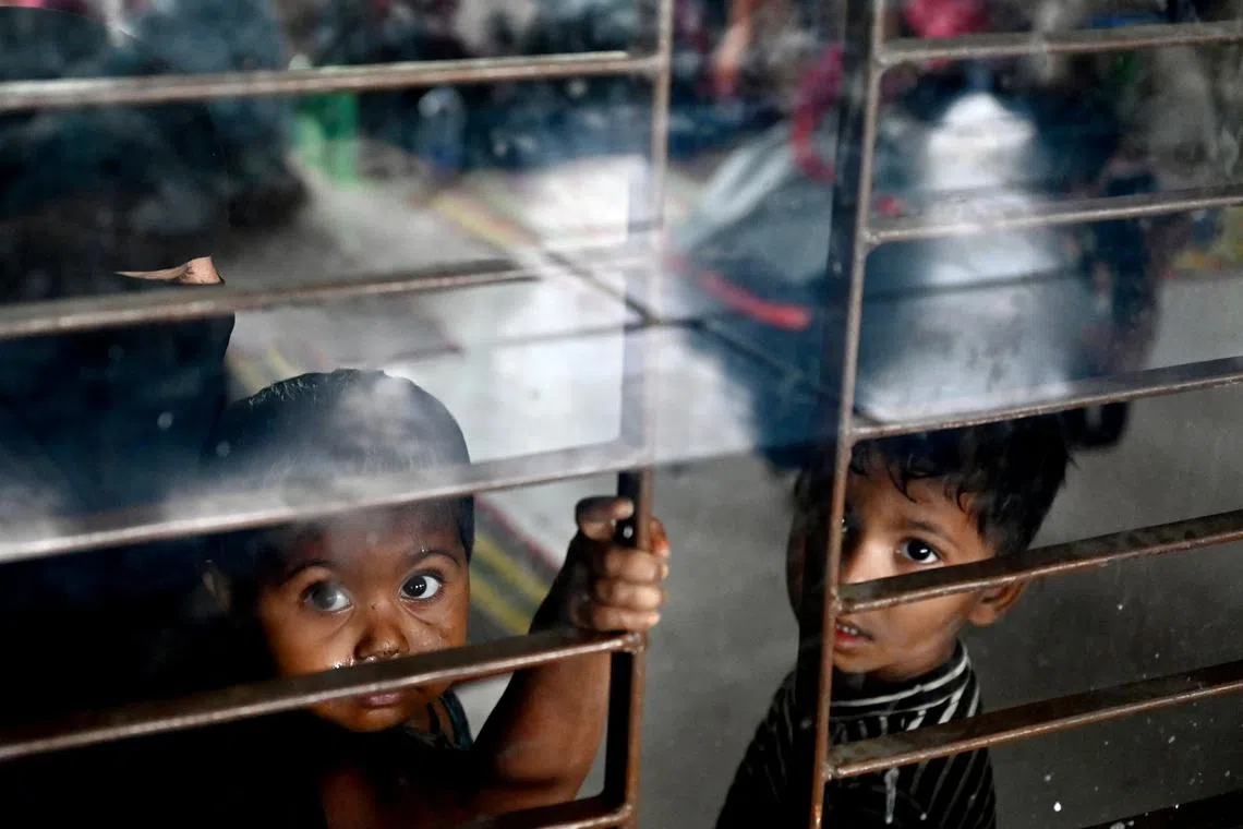 Children taking shelter in Shahpori island on the outskirts of Teknaf, on May 14, ahead of Cyclone Mocha's landfall. 