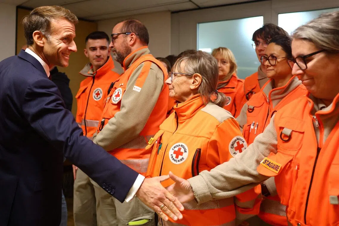 France’s President Emmanuel Macron meeting rescue forces at the town hall following a shooting in Trappes, near Paris on Oct 23.