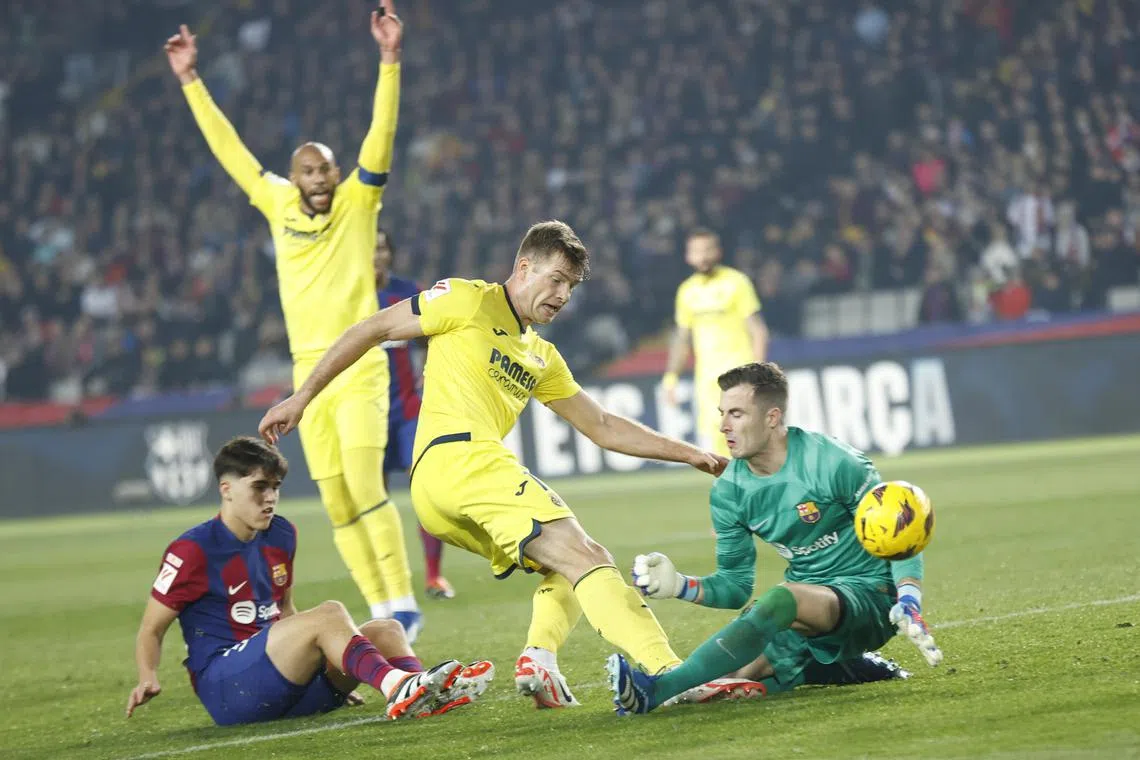 Villarreal's Alexander Sorloth (centre) scores their fourth goal against Barcelona.