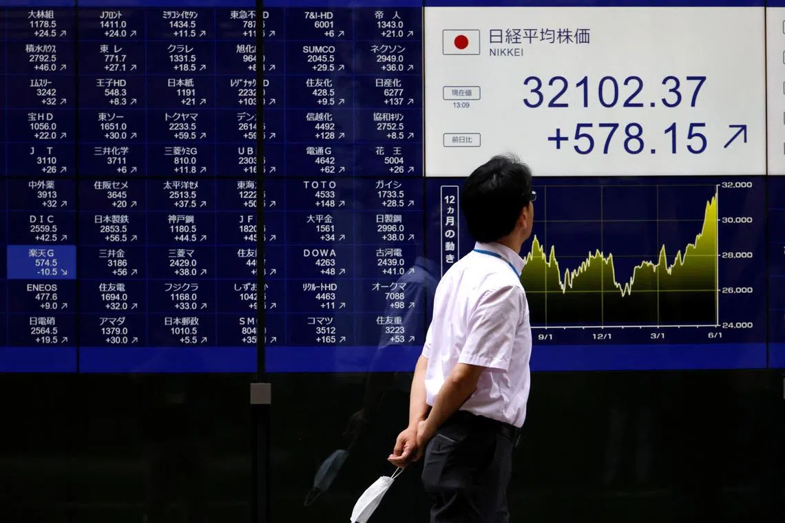 A man looks at an electric monitor displaying a stock quotation board outside a bank in Tokyo, Japan, June 5, 2023. REUTERS/Issei Kato 