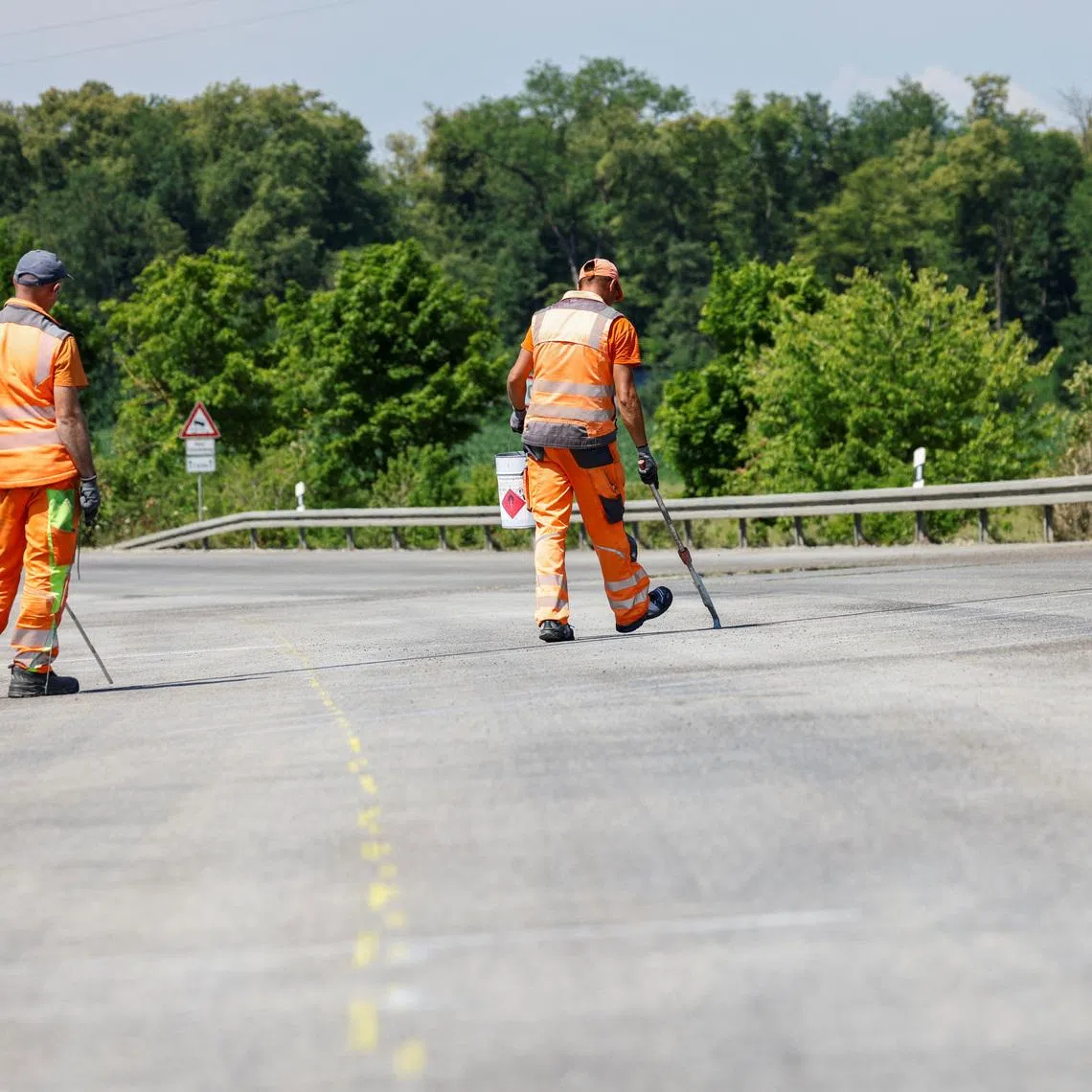 Construction workers mark the road near Germering, Germany July 1, 2025. REUTERS/Michaela Stache
