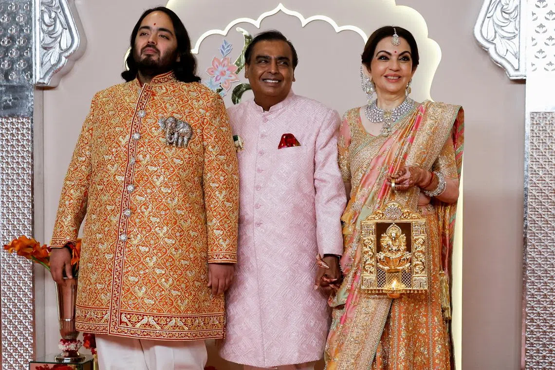 Groom Anant Ambani poses for pictures with Nita Ambani and Mukesh Ambani on the red carpet on the day of his wedding with Radhika Merchant in Mumbai, India, July 12, 2024. REUTERS/Francis Mascarenhas