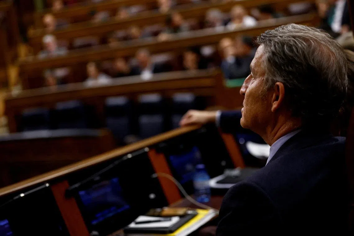FILE PHOTO: Spain's opposition leader and People's Party president Alberto Nunez Feijoo attends a vote on a fiscal package extending a windfall tax on banks at Parliament, in Madrid, Spain, November 21, 2024. REUTERS/Susana Vera/File Photo