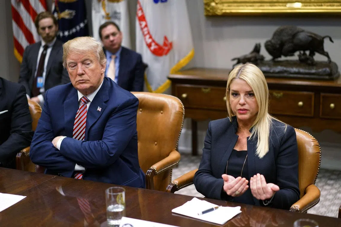 (FILES) US President Donald Trump (L) watches as Florida Attorney General Pam Bondi speaks during a meeting with state and local officials on school safety in the Roosevelt Room of the White House on February 22, 2018 in Washington, DC. US President-elect Donald Trump tapped Pam Bondi, a staunch ally who helped defend the ex-leader against impeachment and joined lawyers who sought to overturn President Joe Biden's election, as US attorney general on November 21, 2024. (Photo by MANDEL NGAN / AFP)