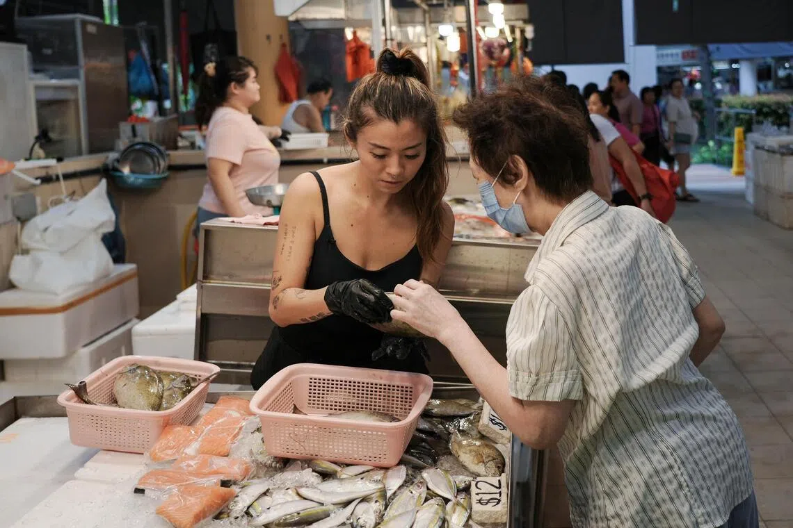 Ms Neo Hui Qin (left) with a customer at her stall at Tiong Bahru Market on Jan 27.