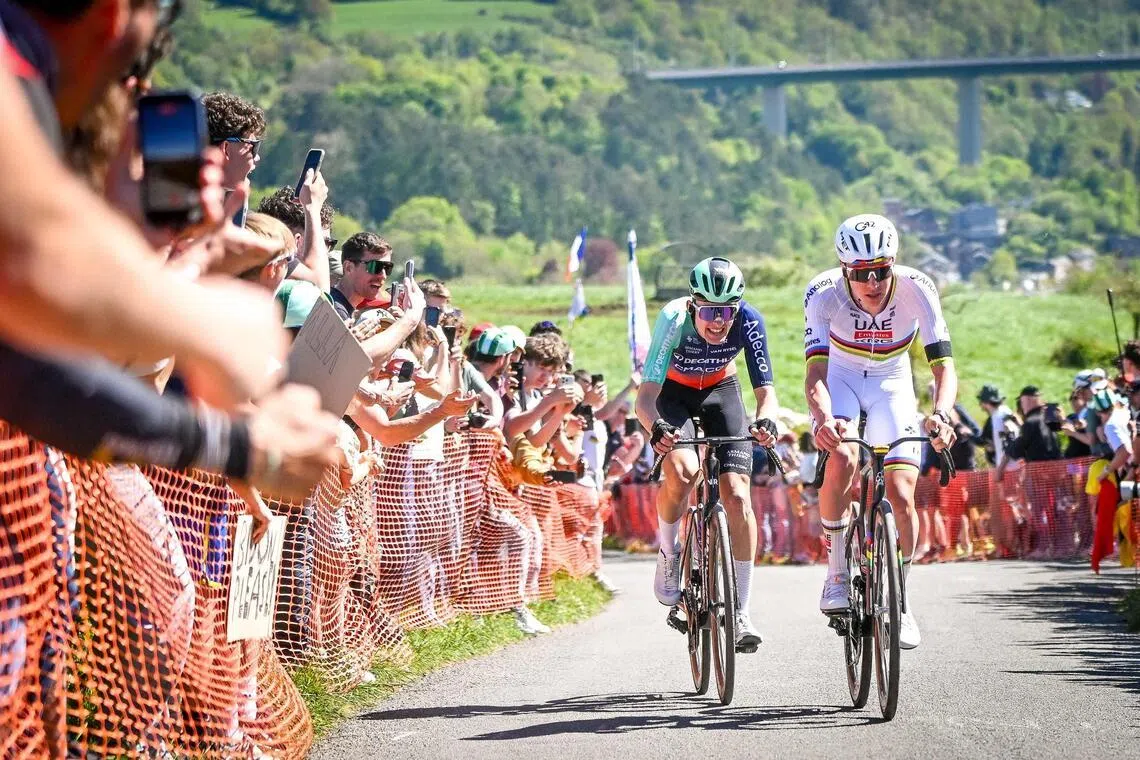 Decathlon CMA-CGM Team's French rider Paul Seixas (left) and UAE Team Emirates-XRG's Slovenian rider Tadej Pogacar in the men's elite race of the Liege-Bastogne-Liege UCI World Tour one-day cycling race on April 26, 2026.