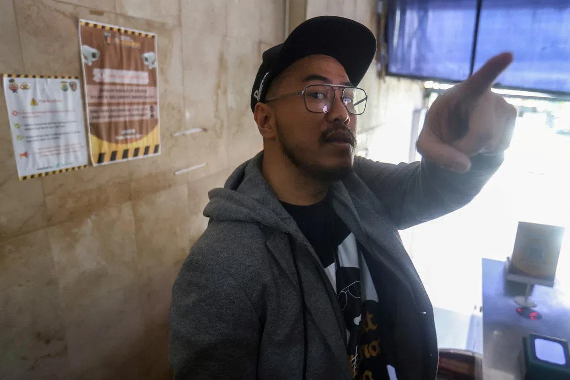 Indonesian comedian Pandji Pragiwaksono, who became the first from Indonesia to air a special on Netflix, gestures as he talks to journalists after he summoned by police over what they called public complaints about the material he used in his stand-up act, at Jakarta regional police headquarters in Jakarta, Indonesia, February 6, 2026. REUTERS/Stringer