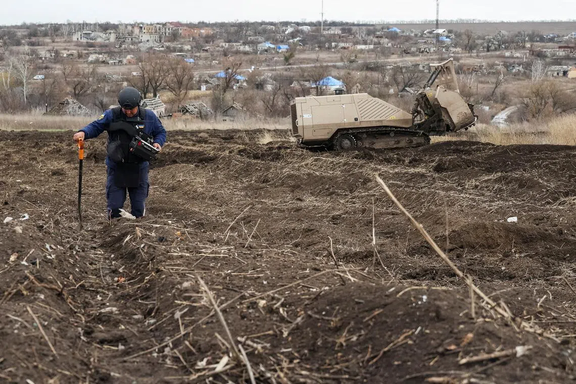 FILE PHOTO: State Emergency Service deminer uses a remote-controlled de-mining vehicle GCS 200 to work on a field near the village of Kamianka destroyed last year by Russian military strike, amid Russia's attack on Ukraine, in Kharkiv region, Ukraine November 8, 2023. REUTERS/Sofiia Gatilova/File Photo