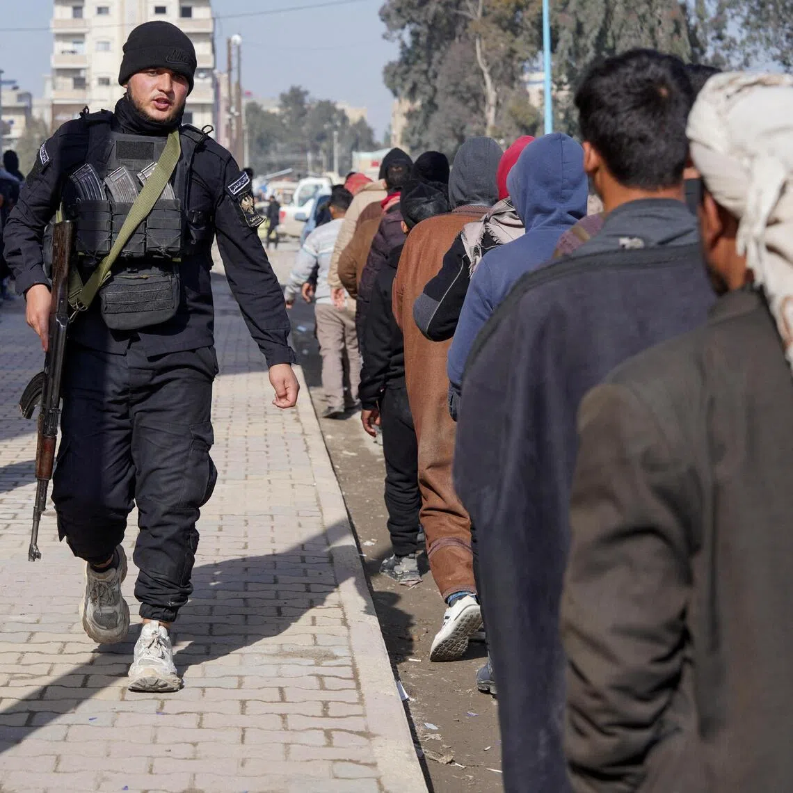 Members of the Kurdish-led Syrian Democratic Forces queuing to settle their status with the Syrian government in Raqqa, Syria, on Jan 27.