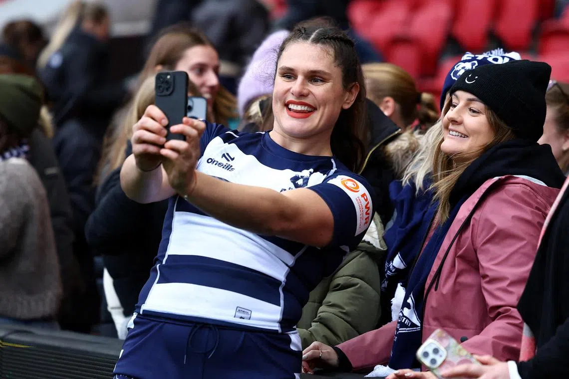 Bristol's Ilona Maher, a social media sensation, takes a welfie with fans after a match. 
