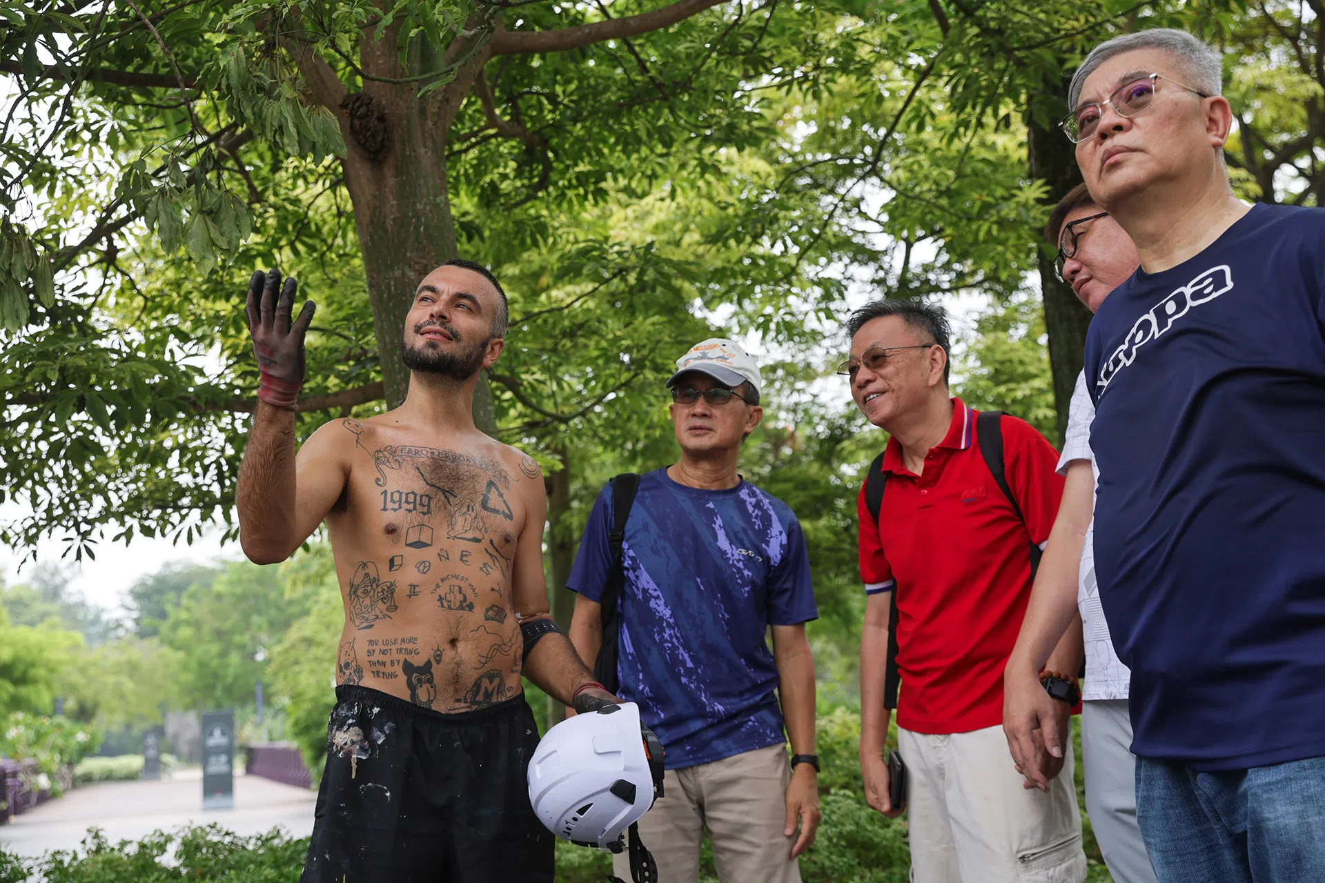 (From left): Portugese artist Artur Bordalo interacting with Mark Heng, 67, retiree, EKO,66, retiree, Lim Hwee Ee, 55, (do not wish to disclose job), and Dennis Lim, 61, event manager, at Gardens By The Bay on Oct 20, 2026.