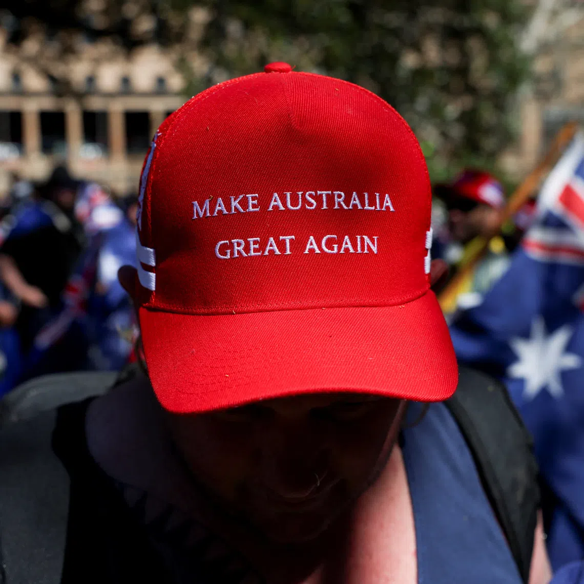 A demonstrator wearing a 'Make Australia Great Again' cap poses for a picture during the 'March for Australia' anti-immigration rally, in Sydney, Australia, August 31, 2025. REUTERS/Hollie Adams