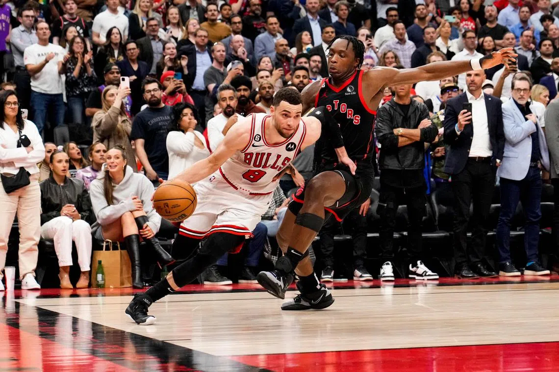 TORONTO, ON - APRIL 12: Zach LaVine #8 of the Chicago Bulls drives past O.G. Anunoby #3 of the Toronto Raptors during the 2023 Play-In Tournament at the Scotiabank Arena on April 12, 2023 in Toronto, Ontario, Canada. NOTE TO USER: User expressly acknowledges and agrees that, by downloading and/or using this Photograph, user is consenting to the terms and conditions of the Getty Images License Agreement.   Andrew Lahodynskyj/Getty Images/AFP (Photo by Andrew Lahodynskyj / GETTY IMAGES NORTH AMERICA / Getty Images via AFP)