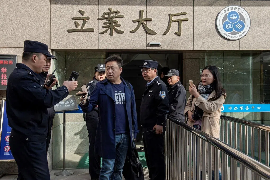Prominent Chinese human rights lawyer Xie Yang (centre), who has defended Christian and pro-democracy activists, was detained in January 2022. 