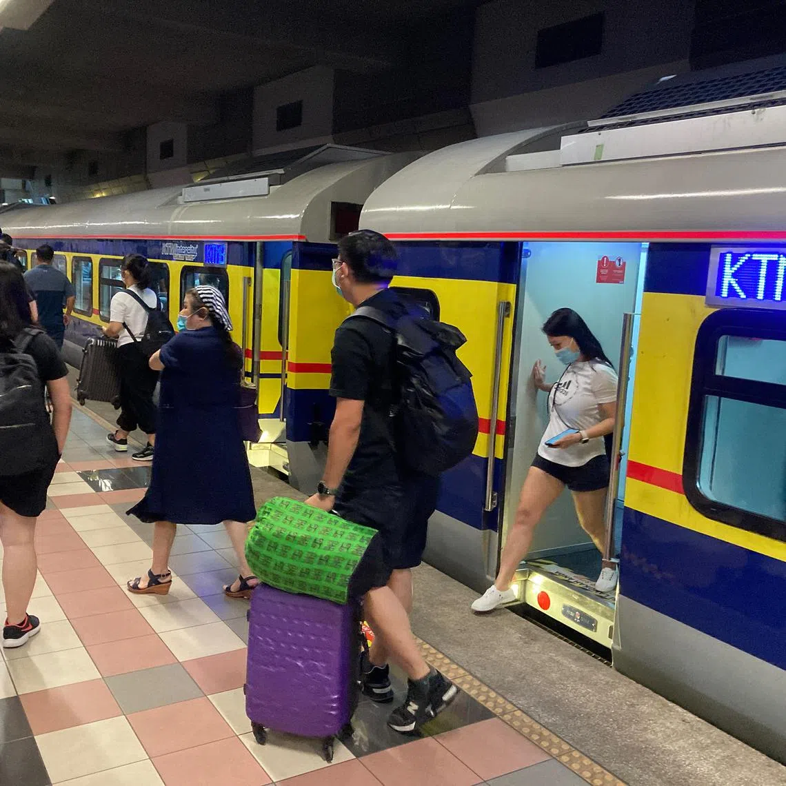 Commuters on the first train from Woodlands to Johor Bahru on June 19, 2022. The Keretapi Tanah Melayu train service, also known as the Tebrau Shuttle, had been suspended due to the pandemic. It now runs 31 trips daily – with 18 from JB Sentral to Woodlands and 13 from Woodlands to JB Sentral.