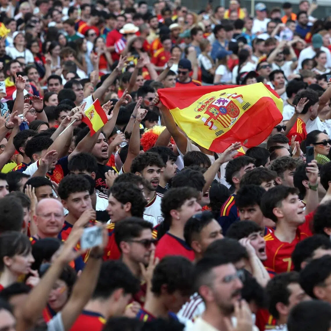 Spain supporters cheer on their team in Madrid.
