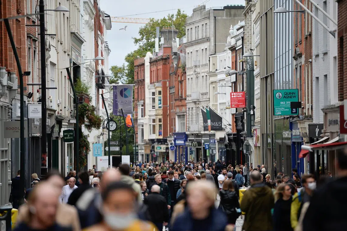 FILE PHOTO: People walk in a busy retail street, after Ireland's Minister for Finance Paschal Donohoe presented the Budget 2022, in Dublin, Ireland, October 12, 2021. REUTERS/Clodagh Kilcoyne/File Photo