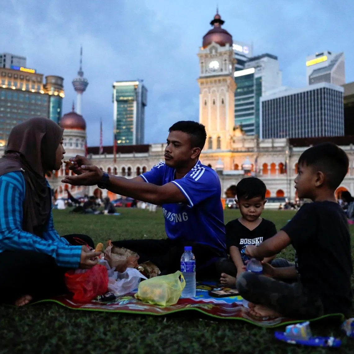 Zulhafiszam Zaidi, 30, and his wife Syafiqah Zahida, 31, break their fast during the holy month of Ramadan in Kuala Lumpur, Malaysia March 24, 2023. REUTERS/Hasnoor Hussain