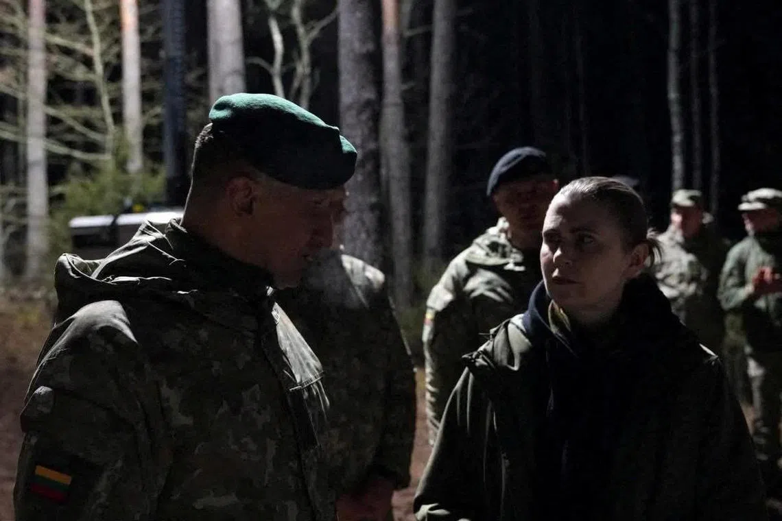 Lithuanian Defence Minister Dovile Sakaliene and Lithuanian Chief of Defence Raimundas Vaiksnoras visiting the site of rescue operation at a training ground in Lithuania, on March 26.