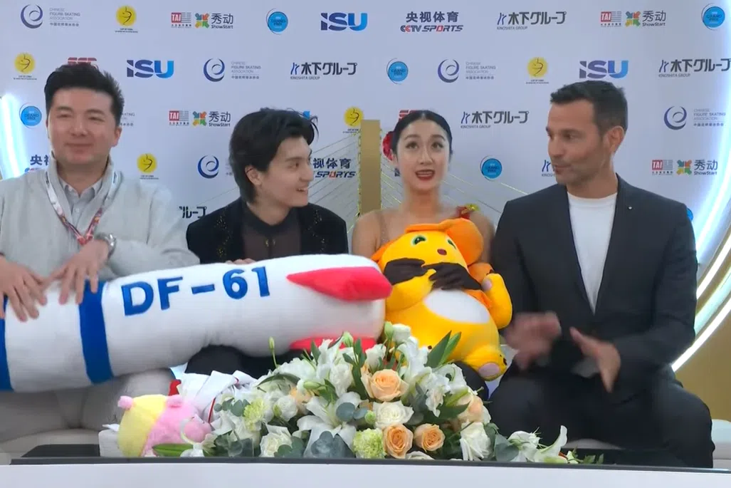 Chinese ice dancers Ren Junfei and Xing Jianing were caught on camera holding a large plushie missile labelled DF-61.