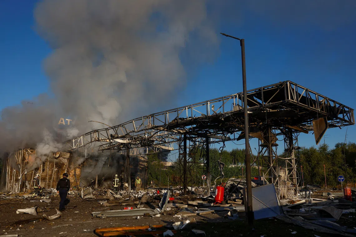 Firefighters work at the site of a petrol station hit by a Russian drone strike in Kyiv, Ukraine on Sept 23.