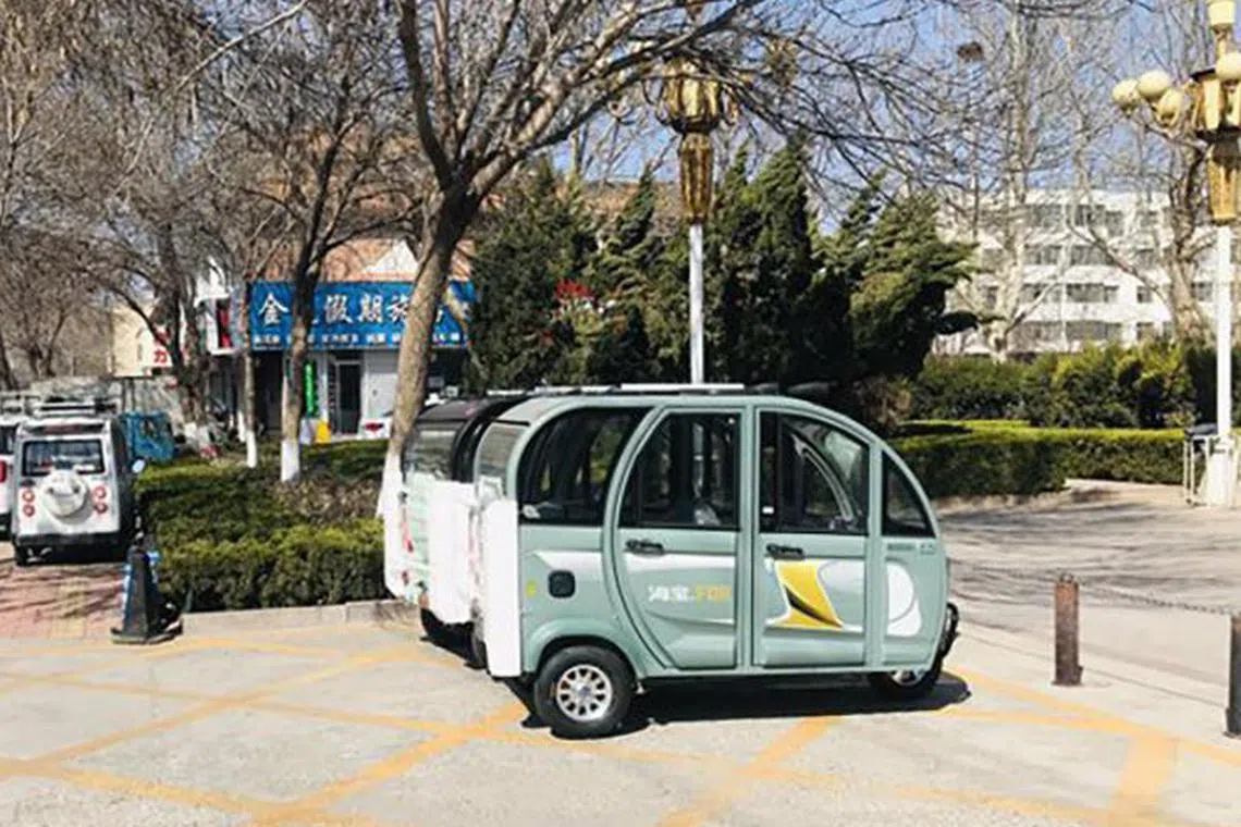 Electric four-wheelers parked on the side of a street in Shanghe county, Shandong province, China.


