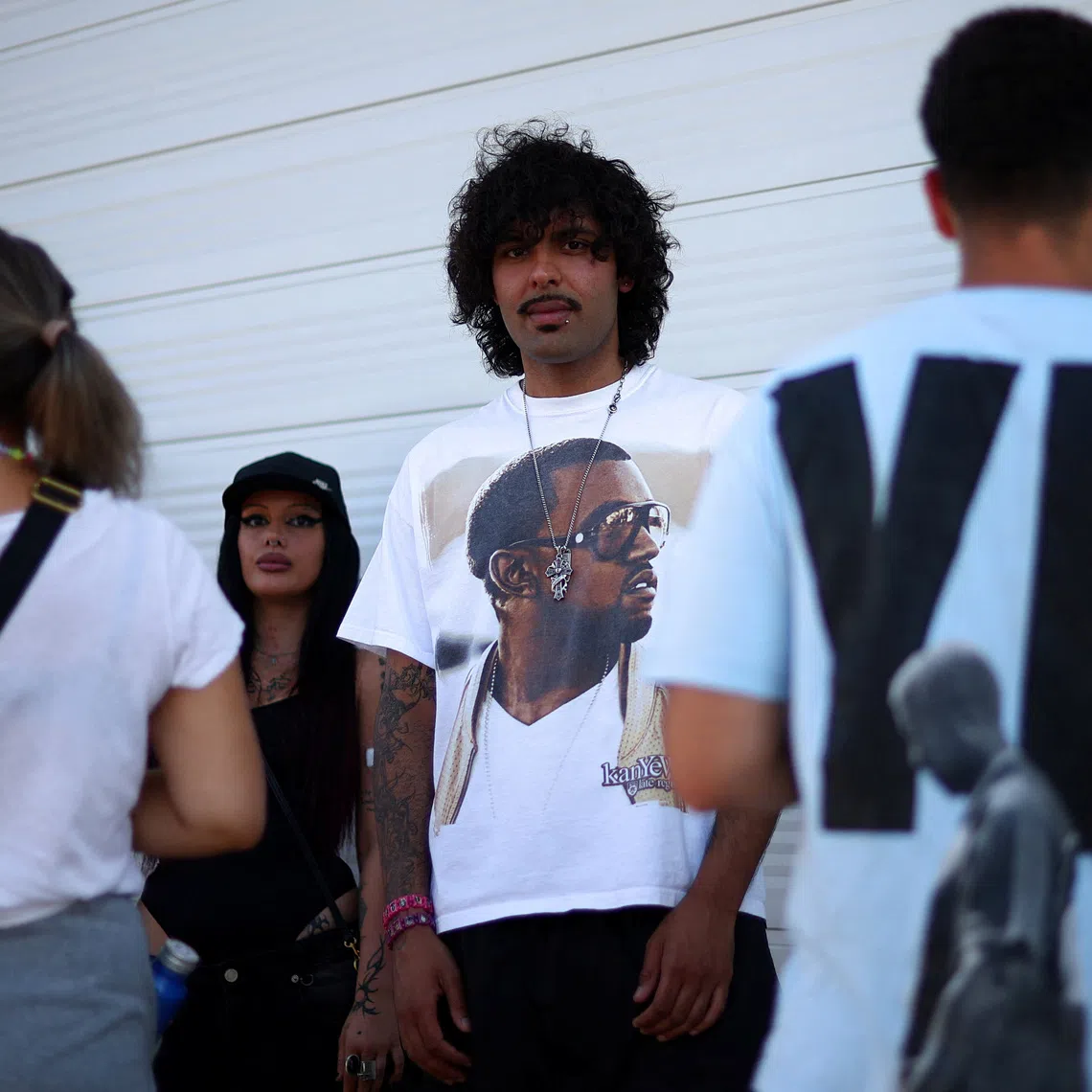 A man wearing a shirt bearing the image of US rapper Kanye West, also known as Ye, ahead of the Kanye concert in Tirana, Albania, on July 11.