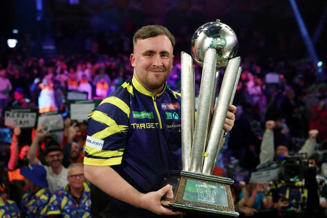 FILE PHOTO: Darts - World Darts Championship - Alexandra Palace, London, Britain - January 3, 2026 Luke Littler poses with the trophy after winning the World Darts Championship Action Images via Reuters/Paul Childs/File Photo