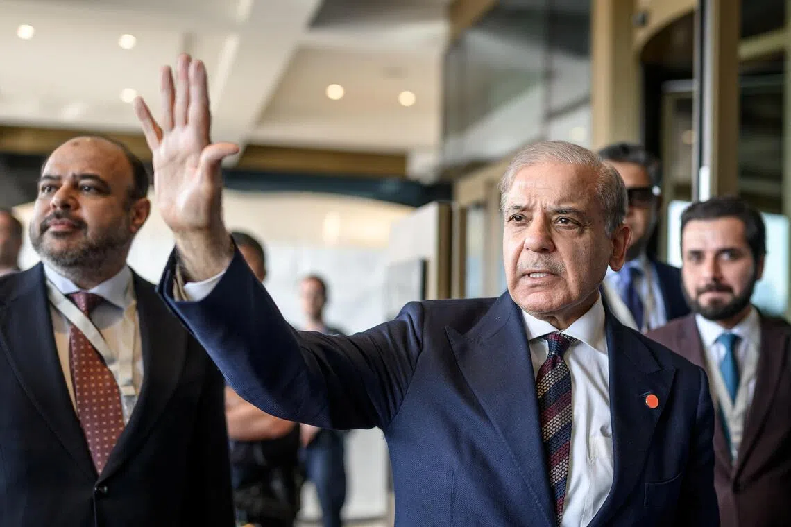 Pakistan’s Prime Minister Muhammad Shehbaz Sharif gestures upon arriving at the Buergenstock luxury hotel complex overlooking Lake Lucerne, Switzerland.