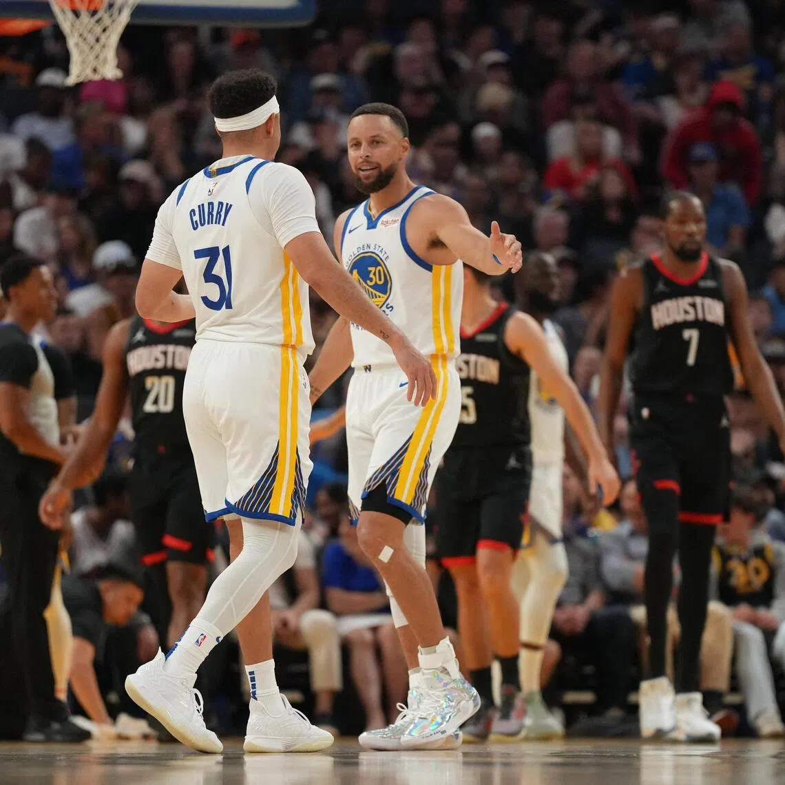 Golden State Warriors guards and brothers  Stephen Curry (right) and Seth Curry after a play against the Houston Rockets in the second quarter on April 6.