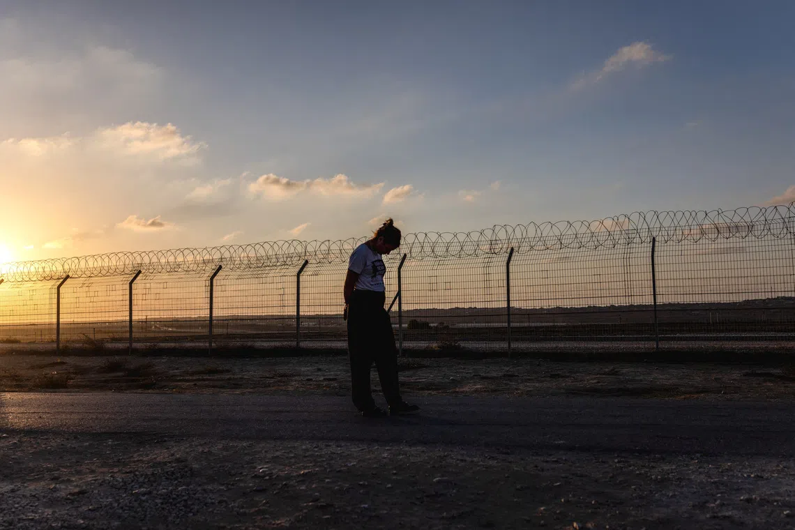 Kibbutz member Yael Raz Lachyani, 49, walks by the fence of Kibbutz Nahal Oz in southern Israel, October 28, 2025. Hamas gunmen killed 15 people from Nahal Oz and took eight more hostage to Gaza on October 7, 2023. REUTERS/Ronen Zvulun