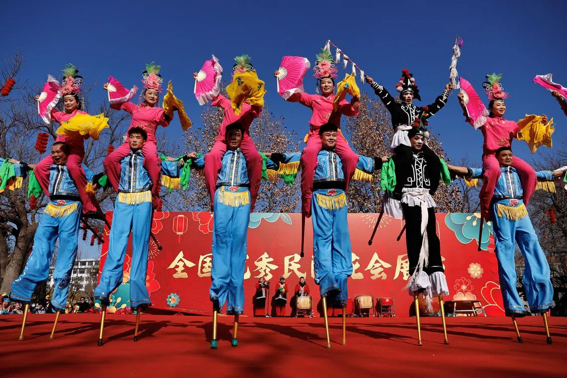 Folk artists performing at a temple fair at a park on the first day of the year of the Dragon amid Lunar New Year celebrations, in Beijing, China Feb 10, 2024. 