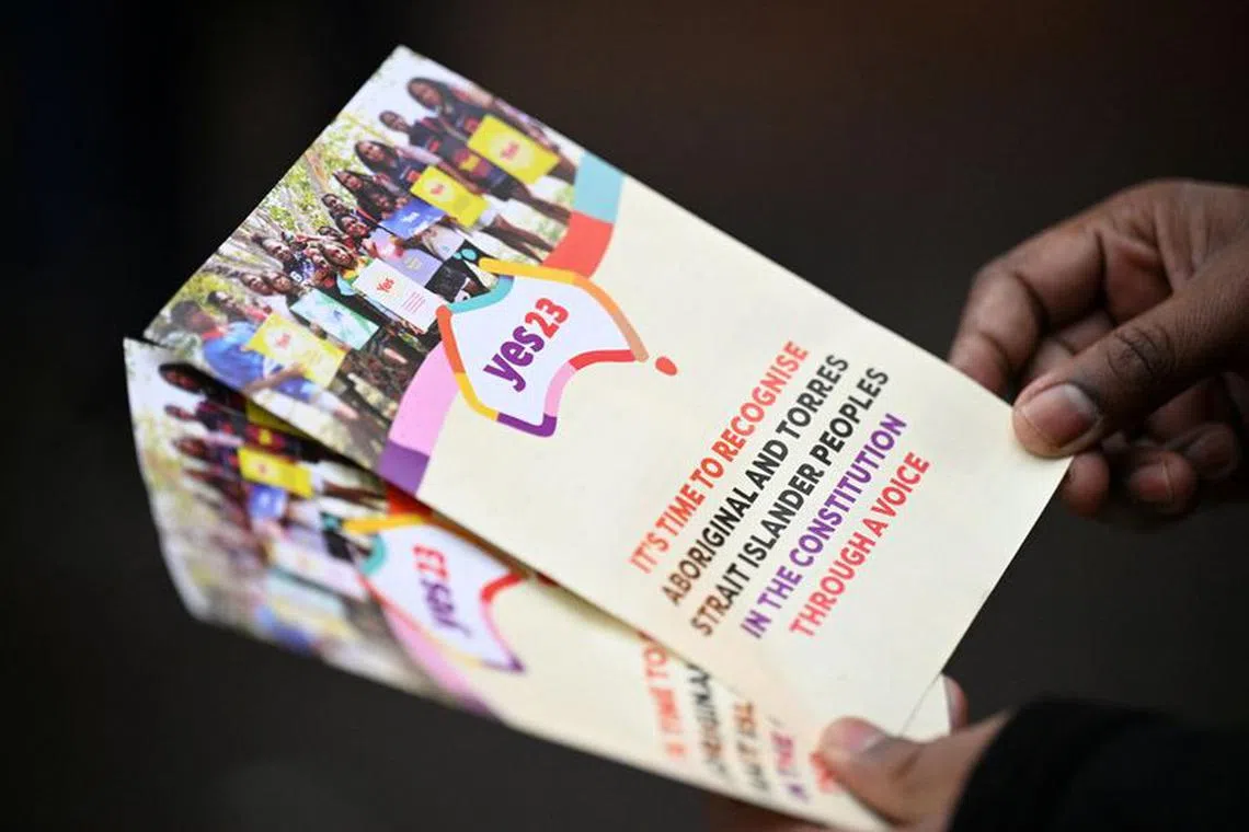A Yes23 volunteer holds pamphlets while speaking with commuters about the upcoming Voice to Parliament referendum, in Melbourne, Australia August 30, 2023.  AAP Image/James Ross via REUTERS