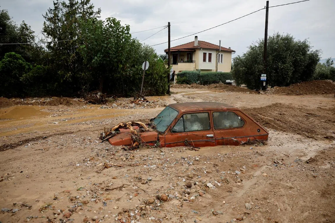 A car is stuck in mud after Storm Elias hit village of Agria, Greece Sept 28.