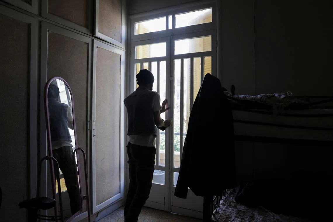 Mohammed, a gay man displaced from southern Lebanon, who spoke to Reuters on condition that his last name not be used, closes the door at a temporary shelter for displaced people in Beirut, Lebanon, May 4, 2026. REUTERS/Raghed Waked.