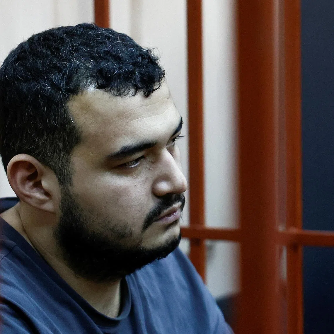 A detainee, named as Uzbek national Akhmad Kurbanov and considered by investigators as a suspect in the murder of chief of Russia's Nuclear, Biological and Chemical Protection Troops Igor Kirillov along with his assistant, sits inside an enclosure for defendants as he attends a court hearing in Moscow, Russia December 19, 2024. REUTERS/Yulia Morozova