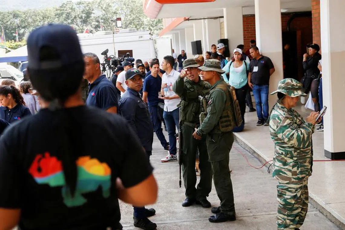 FILE PHOTO: Members of the National Bolivarian Armed Forces of Venezuela organize the people who participate in an electoral simulation before the referendum on December 3 over Venezuela's rights to the potentially oil-rich region of Esequiba in Guyana, in Caracas, Venezuela November 19, 2023. REUTERS/Leonardo Fernandez Viloria/File Photo