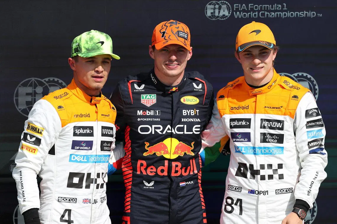 Red Bull's Max Verstappen celebrates after qualifying in pole position, alongside McLaren's Lando Norris and Oscar Piastri.