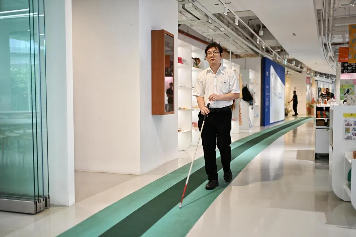Chong Kwek Bin, 45, co-creator of Enable Lane and manager of innovation at SG Enable, walking on Enable Lane at the Enabling Village on Sept 15.