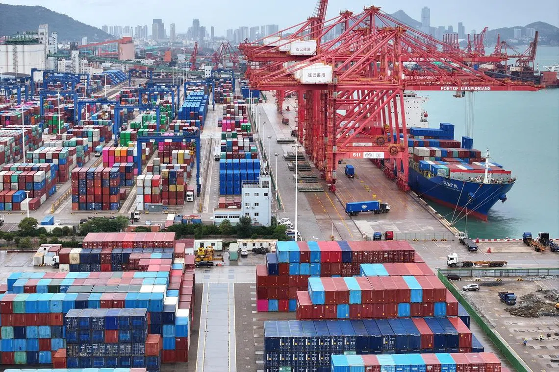A drone view shows a cargo ship and shipping containers at the port of Lianyungang in Jiangsu province, China October 17, 2024. China Daily via REUTERS/File Photo