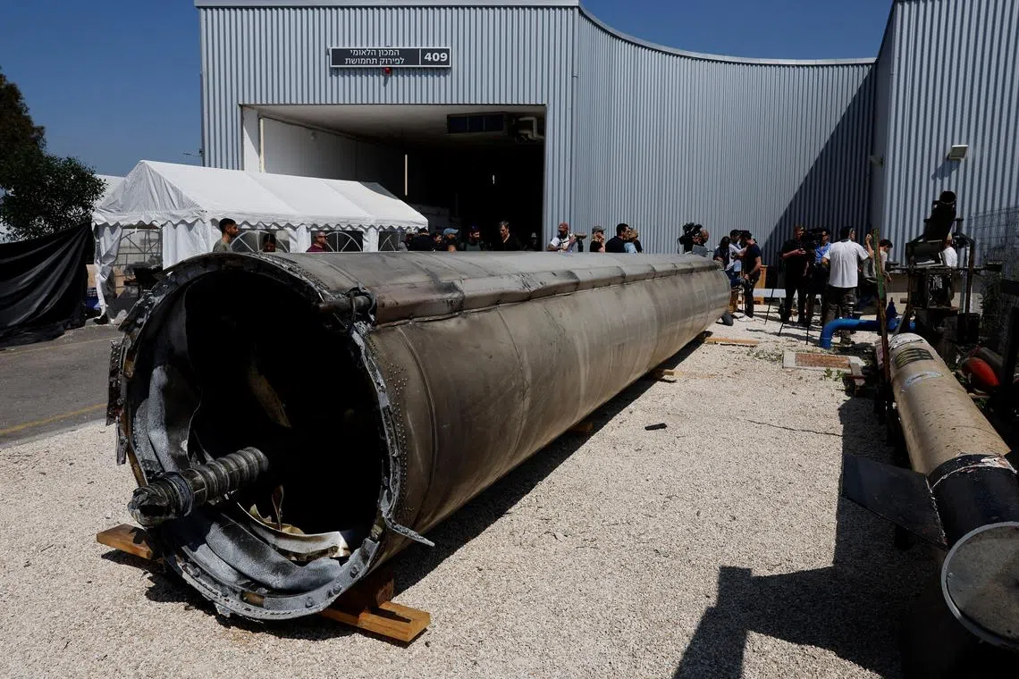 People gather as Israel's military displays what they say is an Iranian ballistic missile which they retrieved from the Dead Sea after Iran launched drones and missiles towards Israel, at Julis military base, in southern Israel April 16, 2024. REUTERS/Amir Cohen