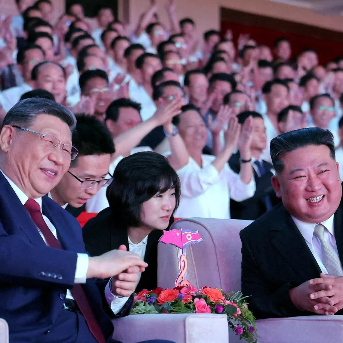 Chinese President Xi Jinping (left) and North Korean leader Kim Jong Un (right) watching a performance at the Pyongyang Indoor Stadium on June 8.