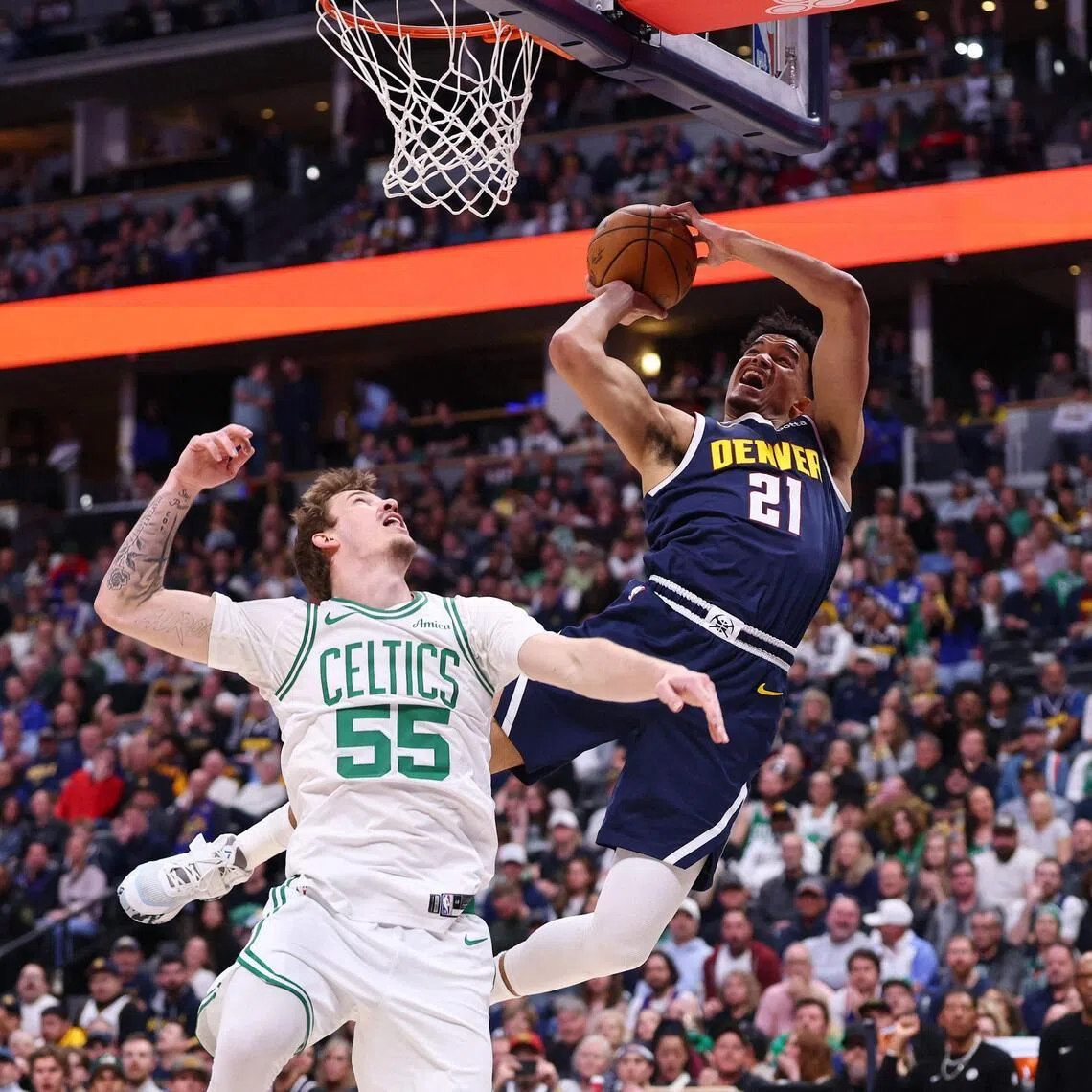 Spencer Jones (No. 21) of the Denver Nuggets going for a shot over the Boston Celtics' Baylor Scheierman during Denver's 103-84 home NBA win on Feb 25.