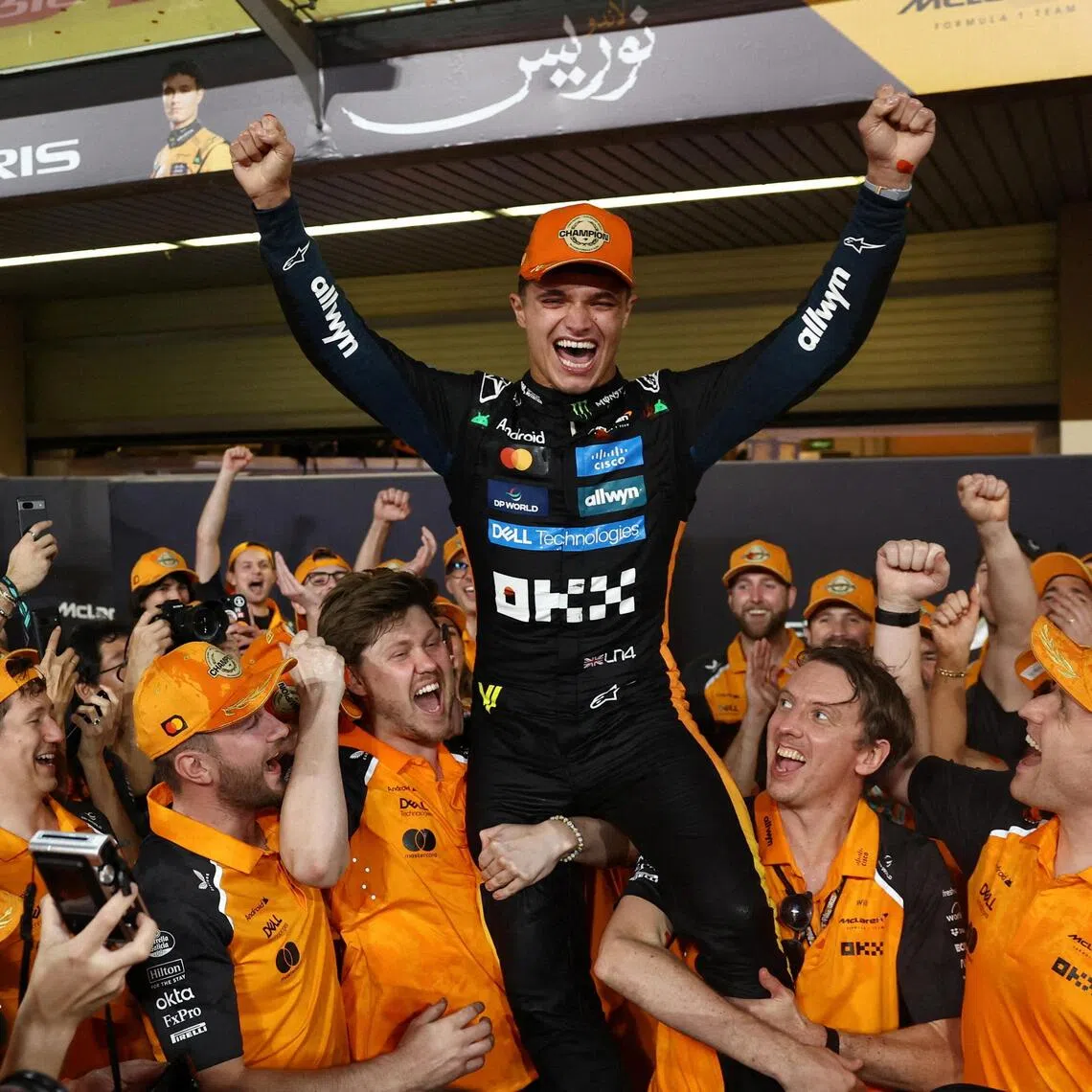 McLaren's Lando Norris celebrates with this team after becoming the 2025 Formula One World Champion.