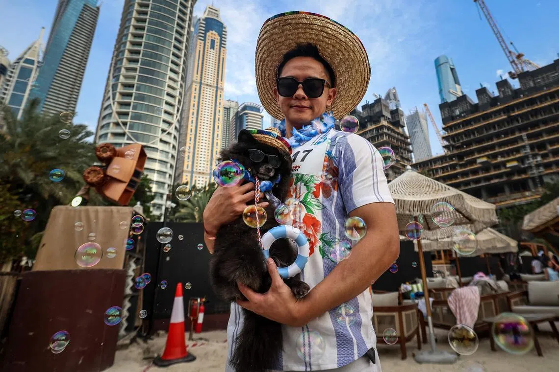 A man poses for a picture with his dog during the Barkfest dog festival at Barasti Beach in Dubai on April 4, 2026. 