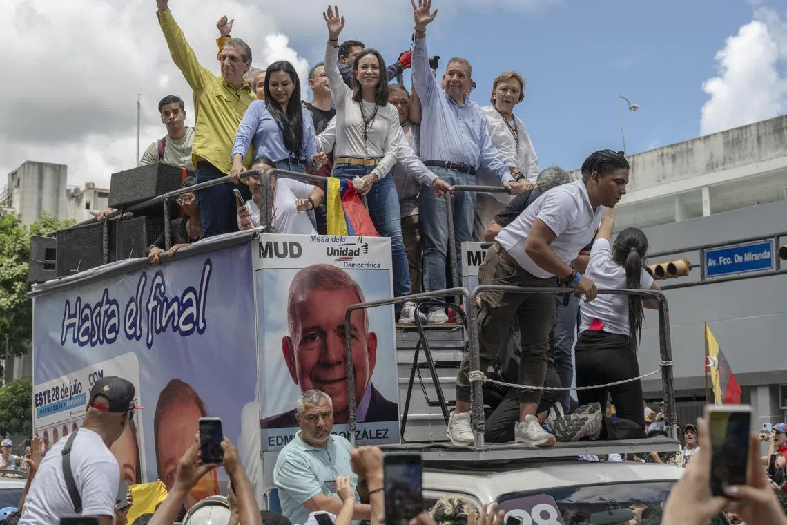 Ms María Corina Machado (centre) and presidential candidate Edmundo Gonzales (centre right) during an opposition rally in Caracas on July 30.